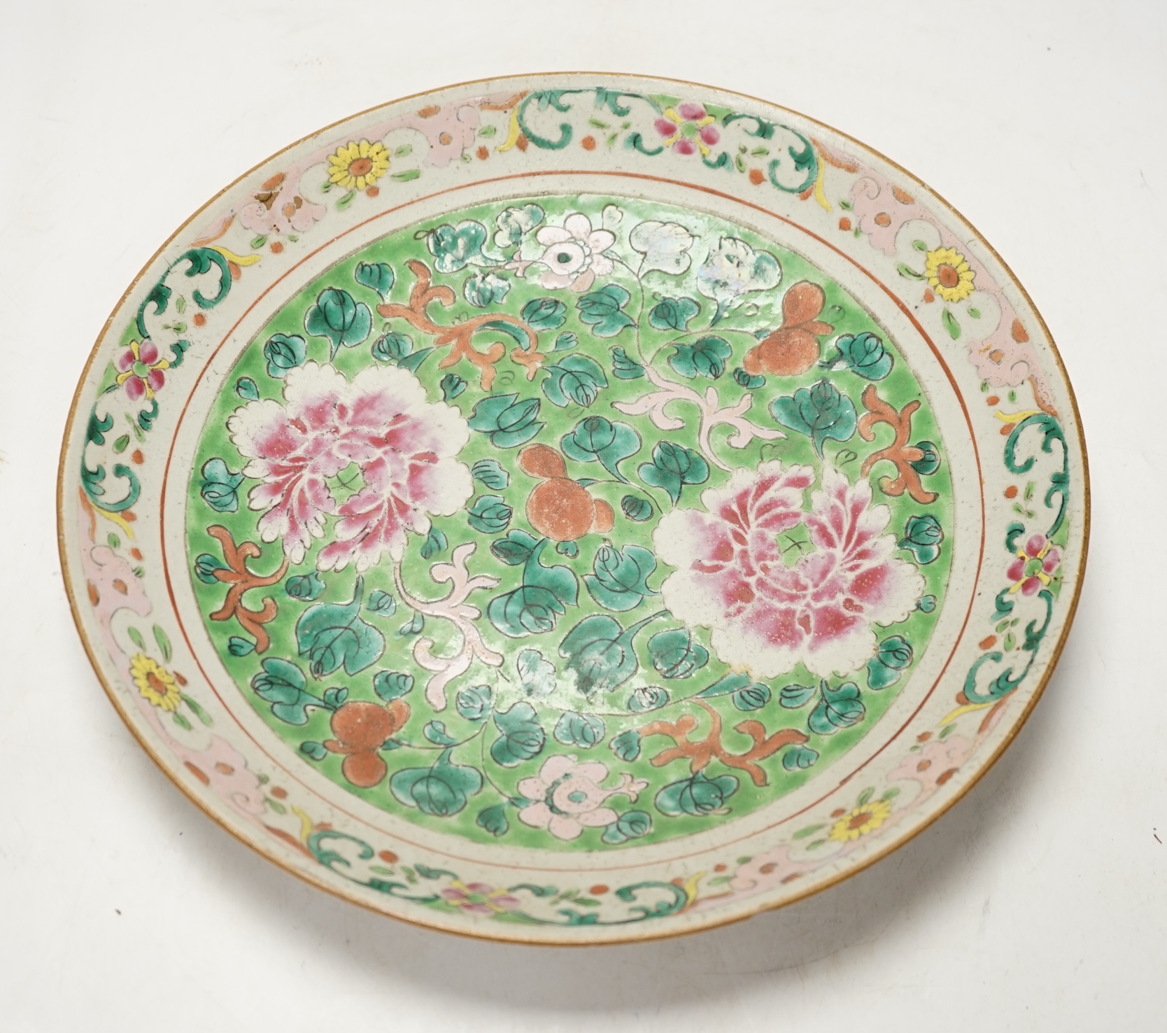 A 19th century Chinese famille rose dish, possibly Thai market, 32cm diameter. Condition - poor to fair
